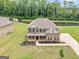Aerial view of the property showcasing the home, large yard, shed and surrounding trees at 149 Elkins Blvd, Locust Grove, GA 30248