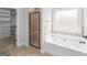 Bright bathroom with a walk-in closet, shower, and tub at 149 Elkins Blvd, Locust Grove, GA 30248