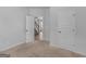 This bedroom shows neutral carpet, blank walls, a door, and plenty of natural light at 149 Elkins Blvd, Locust Grove, GA 30248