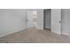 Bedroom featuring carpet floors, an open closet, and doors at 149 Elkins Blvd, Locust Grove, GA 30248