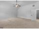 A ceiling fan tops this upstairs bedroom with neutral walls and carpet at 149 Elkins Blvd, Locust Grove, GA 30248