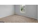 Cozy bedroom with neutral walls and plush carpeting, bathed in natural light at 149 Elkins Blvd, Locust Grove, GA 30248