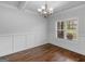 Charming dining room features hardwood floors, decorative wainscoting, and stylish chandelier lighting at 149 Elkins Blvd, Locust Grove, GA 30248