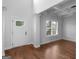Bright foyer with hardwood flooring, a coffered ceiling and paneled door at 149 Elkins Blvd, Locust Grove, GA 30248