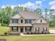 Beautiful two-story home with brick and siding, a manicured lawn, and well-kept landscaping at 149 Elkins Blvd, Locust Grove, GA 30248
