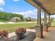 View from the charming front porch showcasing the neighborhood and lush landscaping at 149 Elkins Blvd, Locust Grove, GA 30248