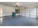 View of the spacious two car garage, epoxy floors, and water heater at 149 Elkins Blvd, Locust Grove, GA 30248