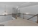 View of the upstairs hallway with decorative chandelier and wrought iron railing at 149 Elkins Blvd, Locust Grove, GA 30248