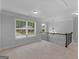 Upstairs hallway with large windows and chandelier at 149 Elkins Blvd, Locust Grove, GA 30248