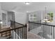 Upstairs hallway with chandelier and view to the stairway at 149 Elkins Blvd, Locust Grove, GA 30248