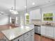 Open kitchen features granite counters, stainless appliances, an island, and hardwood floors at 149 Elkins Blvd, Locust Grove, GA 30248