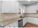 This kitchen features granite countertops, stainless steel appliances, and bright white cabinetry at 149 Elkins Blvd, Locust Grove, GA 30248
