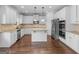 Beautiful kitchen featuring white cabinets, granite countertops, stainless appliances, and hardwood floors at 149 Elkins Blvd, Locust Grove, GA 30248