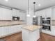 Gourmet kitchen with stainless steel appliances, white cabinets, granite countertops, and center island at 149 Elkins Blvd, Locust Grove, GA 30248