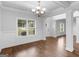 Inviting living area showcases hardwood floors, wainscoting, and large windows for ample natural light at 149 Elkins Blvd, Locust Grove, GA 30248
