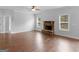 Bright living space boasts hardwood floors, a stone fireplace, and large windows for plenty of light at 149 Elkins Blvd, Locust Grove, GA 30248