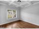 Inviting living space showcasing hardwood floors and a view of the landscaped yard at 149 Elkins Blvd, Locust Grove, GA 30248