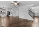 Spacious living room has hardwood floors, staircase, and flows seamlessly into a modern kitchen at 149 Elkins Blvd, Locust Grove, GA 30248