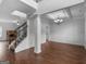 Open-concept living area with hardwood floors, paneled walls, and an iron railing staircase at 149 Elkins Blvd, Locust Grove, GA 30248