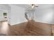 Hardwood floors grace this inviting living space near a staircase, bathroom, and front door at 149 Elkins Blvd, Locust Grove, GA 30248