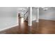 Hardwood floors connect the open living space showcasing stone fireplace and staircase at 149 Elkins Blvd, Locust Grove, GA 30248