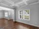 Hardwood floors highlight the open floor plan and staircase with stone fireplace in the background at 149 Elkins Blvd, Locust Grove, GA 30248