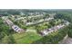 Aerial view of a peaceful residential neighborhood, dotted with lush trees and manicured lawns at 401 Buckboard Ln, Locust Grove, GA 30248