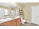 Bathroom with a double sink vanity, toilet and tile flooring at 401 Buckboard Ln, Locust Grove, GA 30248
