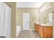 Bathroom with a double sink vanity, bathtub and shower combination and tile flooring at 401 Buckboard Ln, Locust Grove, GA 30248