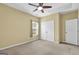 Bedroom with a ceiling fan, window and double door closet at 401 Buckboard Ln, Locust Grove, GA 30248