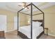 Spacious bedroom with a four-poster bed, ceiling fan and lots of natural light at 401 Buckboard Ln, Locust Grove, GA 30248