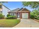 Charming brick home with a well-manicured lawn, attached garage, and beautiful landscaping at 401 Buckboard Ln, Locust Grove, GA 30248