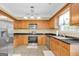 Functional kitchen featuring stainless steel appliances, ample cabinet space, and a granite countertop at 401 Buckboard Ln, Locust Grove, GA 30248