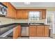 Functional kitchen featuring stainless steel appliances, wood cabinets, and a granite countertop at 401 Buckboard Ln, Locust Grove, GA 30248
