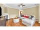 Cozy living room featuring a comfortable sectional, a fireplace, modern furniture, and hardwood floors at 401 Buckboard Ln, Locust Grove, GA 30248