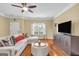 Inviting living room featuring a plush sectional, contemporary furnishings, and ample natural light at 401 Buckboard Ln, Locust Grove, GA 30248