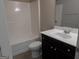 Clean bathroom with a combination tub and shower unit and a dark vanity at 3511 Brockenhurst Dr, Buford, GA 30519