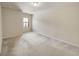 Bright bedroom featuring neutral carpet and a large window at 3511 Brockenhurst Dr, Buford, GA 30519
