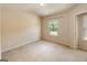 Bedroom featuring neutral carpet, white walls, and a window offering natural light at 3511 Brockenhurst Dr, Buford, GA 30519