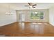 Bright living room with hardwood floors and large windows overlooking the backyard at 3511 Brockenhurst Dr, Buford, GA 30519
