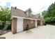 Exterior of the pool house featuring brick and vinyl siding with concrete walkway at 3511 Brockenhurst Dr, Buford, GA 30519