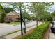 Street view with a well manicured lawn and townhome exteriors at 3511 Brockenhurst Dr, Buford, GA 30519