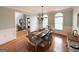 Elegant dining room with chandelier, wainscoting, and hardwood floors at 99 Oakwind Pt, Acworth, GA 30101