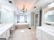 Bright, spacious main bathroom with separate vanities, tub, and tile floor at 99 Oakwind Pt, Acworth, GA 30101