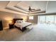 Large main bedroom with trey ceiling, sitting area, and plush carpeting at 99 Oakwind Pt, Acworth, GA 30101
