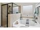 Bright bathroom featuring a soaking tub, separate shower, and neutral-colored tile surround at 3225 Alhambra Cir, Hampton, GA 30228
