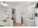 Bright bathroom with dual vanities, neutral tile flooring, and a separate room with toilet and shower at 3225 Alhambra Cir, Hampton, GA 30228