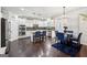 Modern kitchen with white cabinetry, stainless steel appliances, a center island, and a cozy dining area at 3225 Alhambra Cir, Hampton, GA 30228