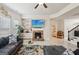 Bright living room showcasing a fireplace, built-in shelves, large windows, and comfortable seating at 3225 Alhambra Cir, Hampton, GA 30228
