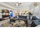 Bright living room with tile floors, large sectional sofa, ceiling fan, and ample natural light at 3225 Alhambra Cir, Hampton, GA 30228